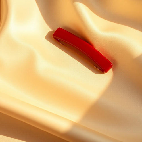 Cherry red hair clip on cream silk